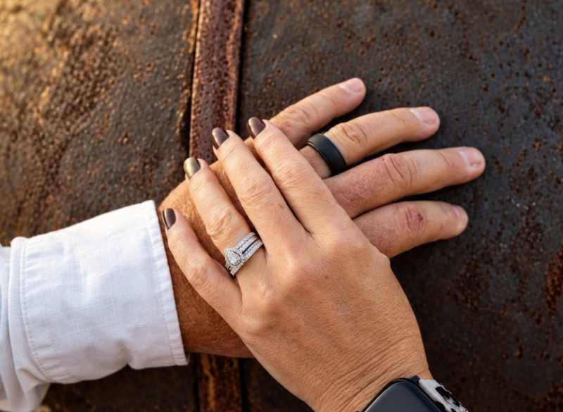 Close-up of wedding rings and joined hands