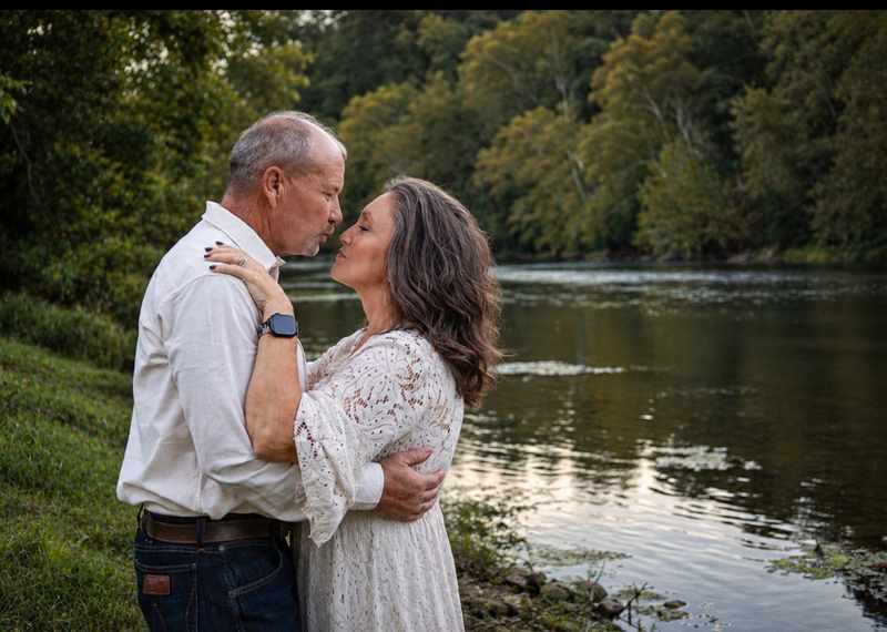 Anniversary couple sharing a quiet moment by the water