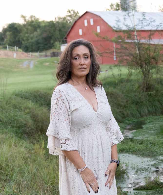 Portrait in front of a red barn